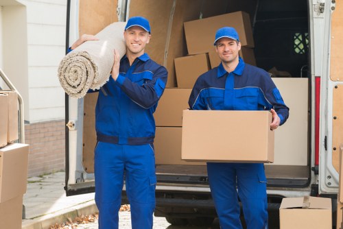 Upright piano being carefully protected for transport