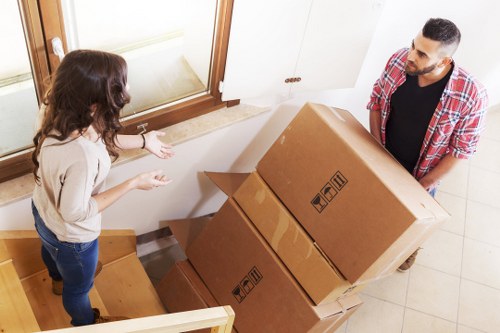 Movers using protective equipment while handling household items
